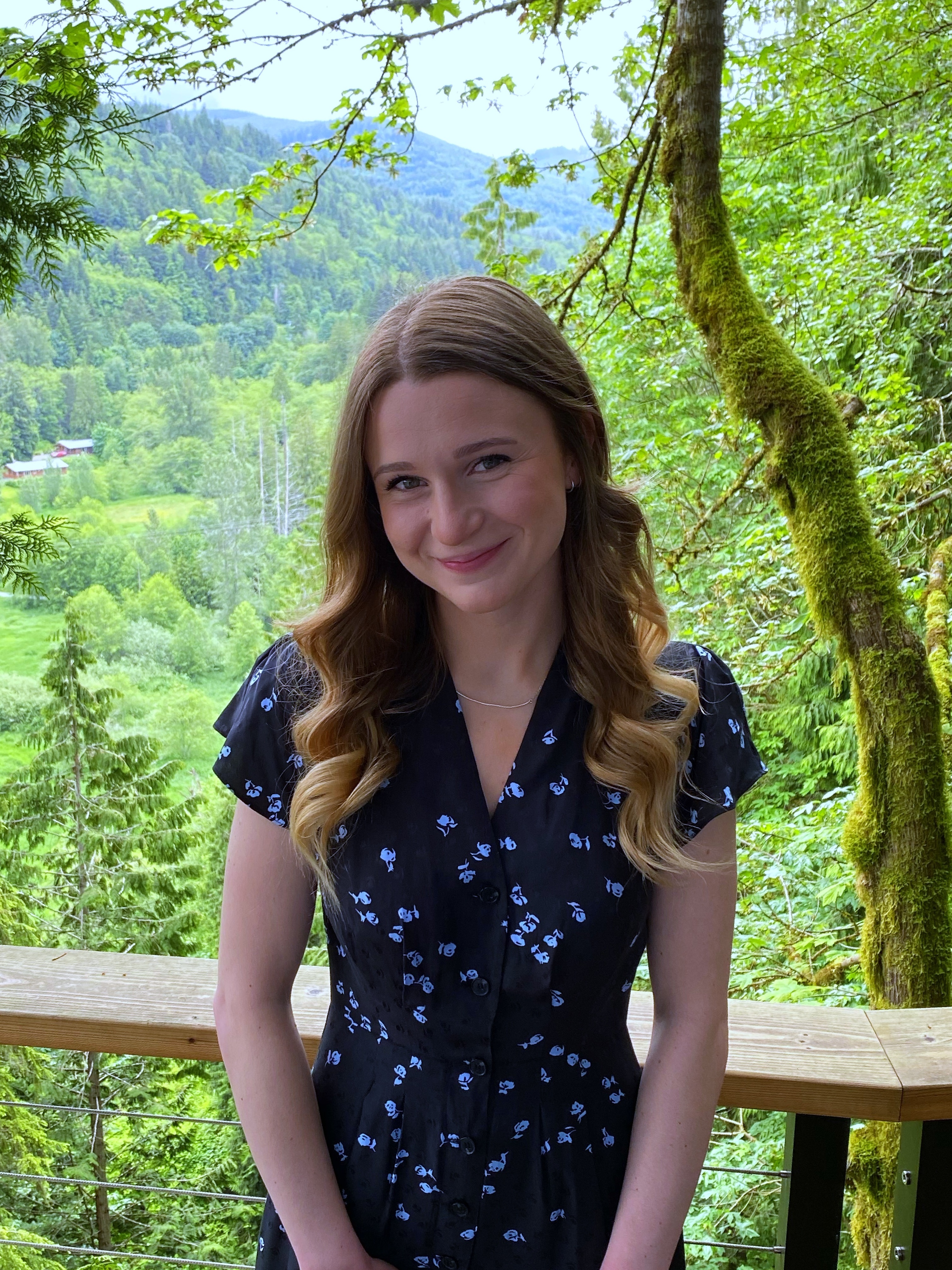 WWU outstanding graduate student Kyllie Gliessman smiling with greenery in the backgroudn