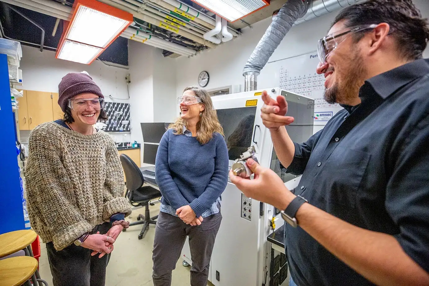 Western Washington University grad student Haley Holliday, left, laughs in the lab with faculty mentors Kathryn Sobocinski and Manuel Montano.