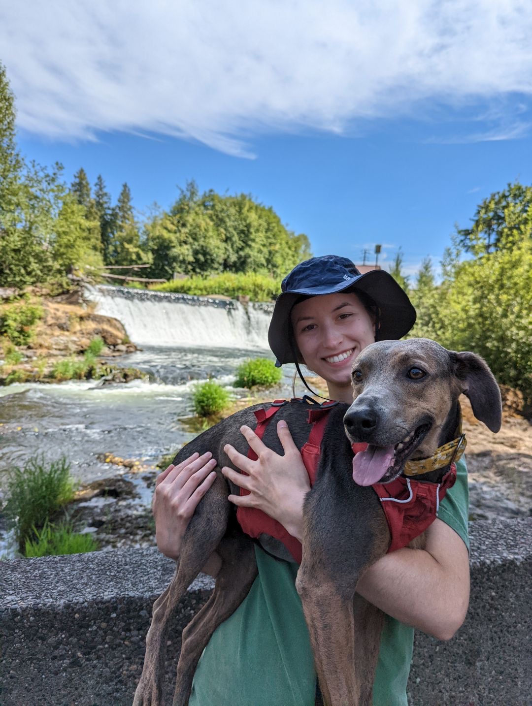 WWU Outstanding Grad Student Haley Sefi-Cyr smiling and holding a dog outside