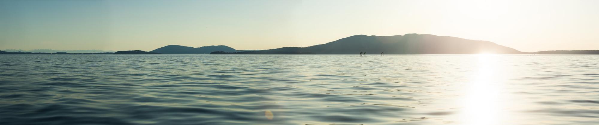 view of Bellingham Bay, Lummi Island, with paddleboarders
