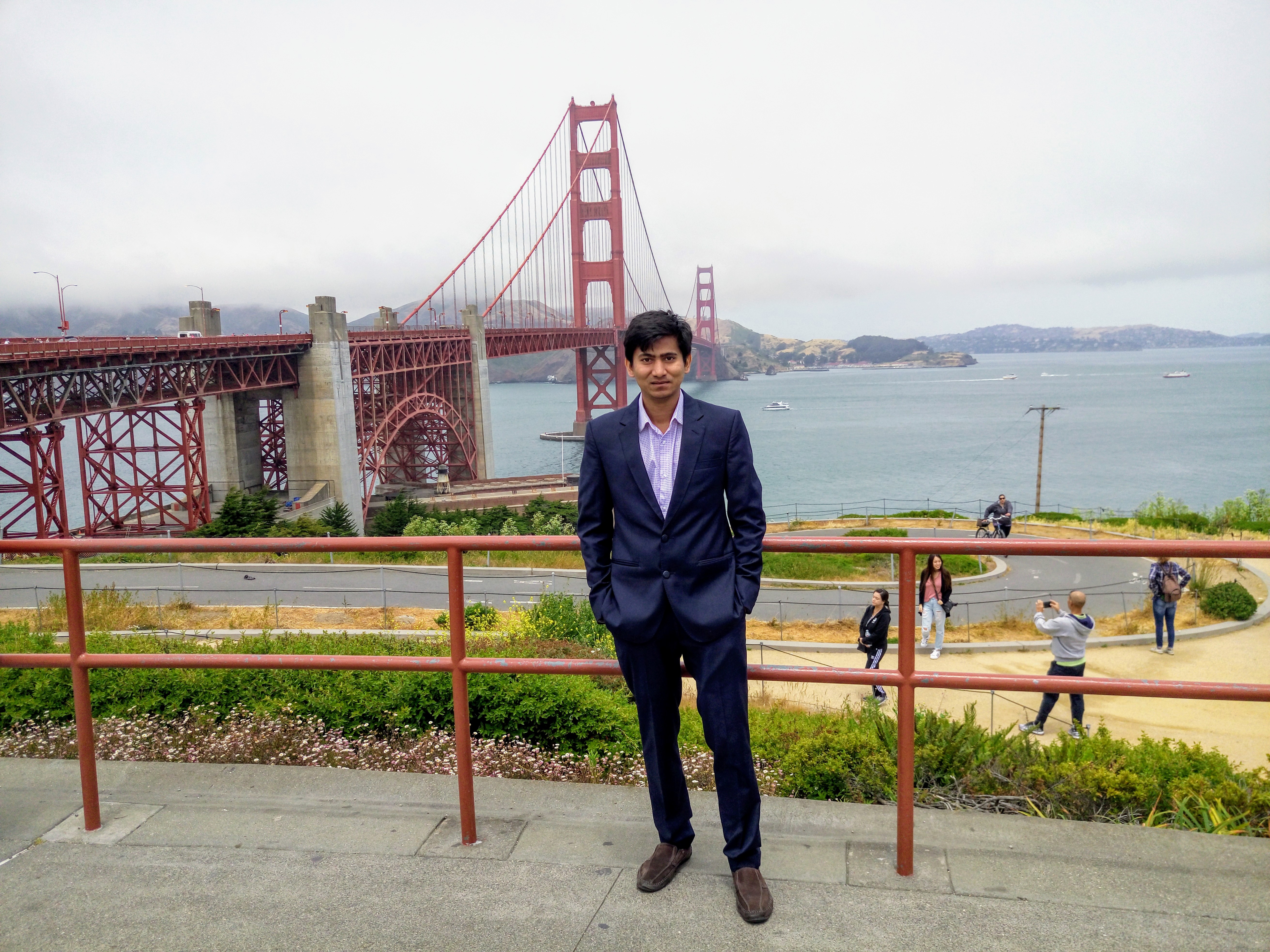 Monsur Hossain in a dark suit near the Golden Gate Bridge