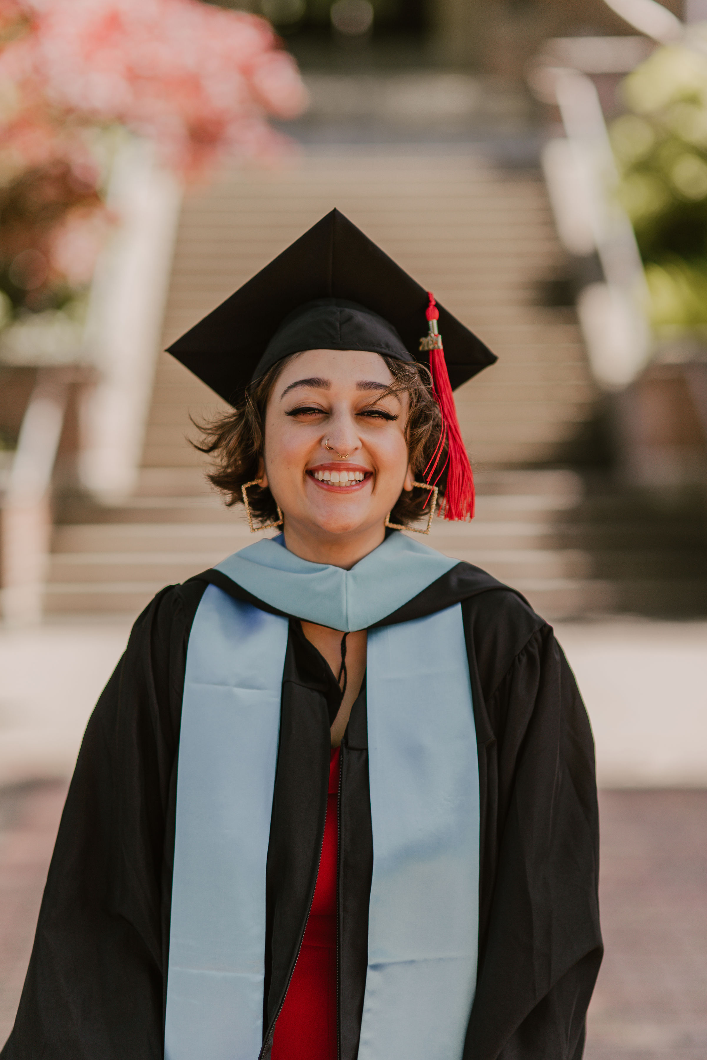 WWU graduate Amrit Abbasi smiling in hood and gown